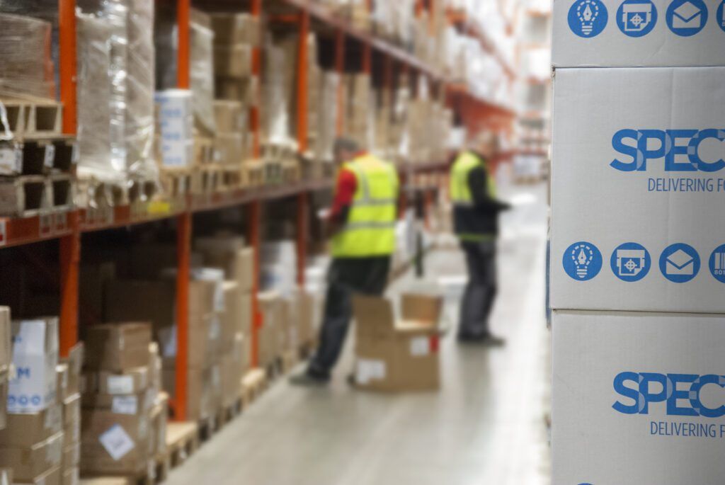spectrum warehouse blur picture with two workers pick items and spectrum boxes